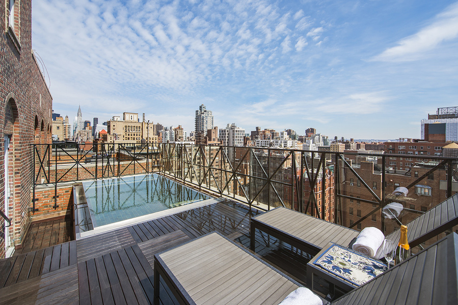 Above rooftop swimming pool with skyline views